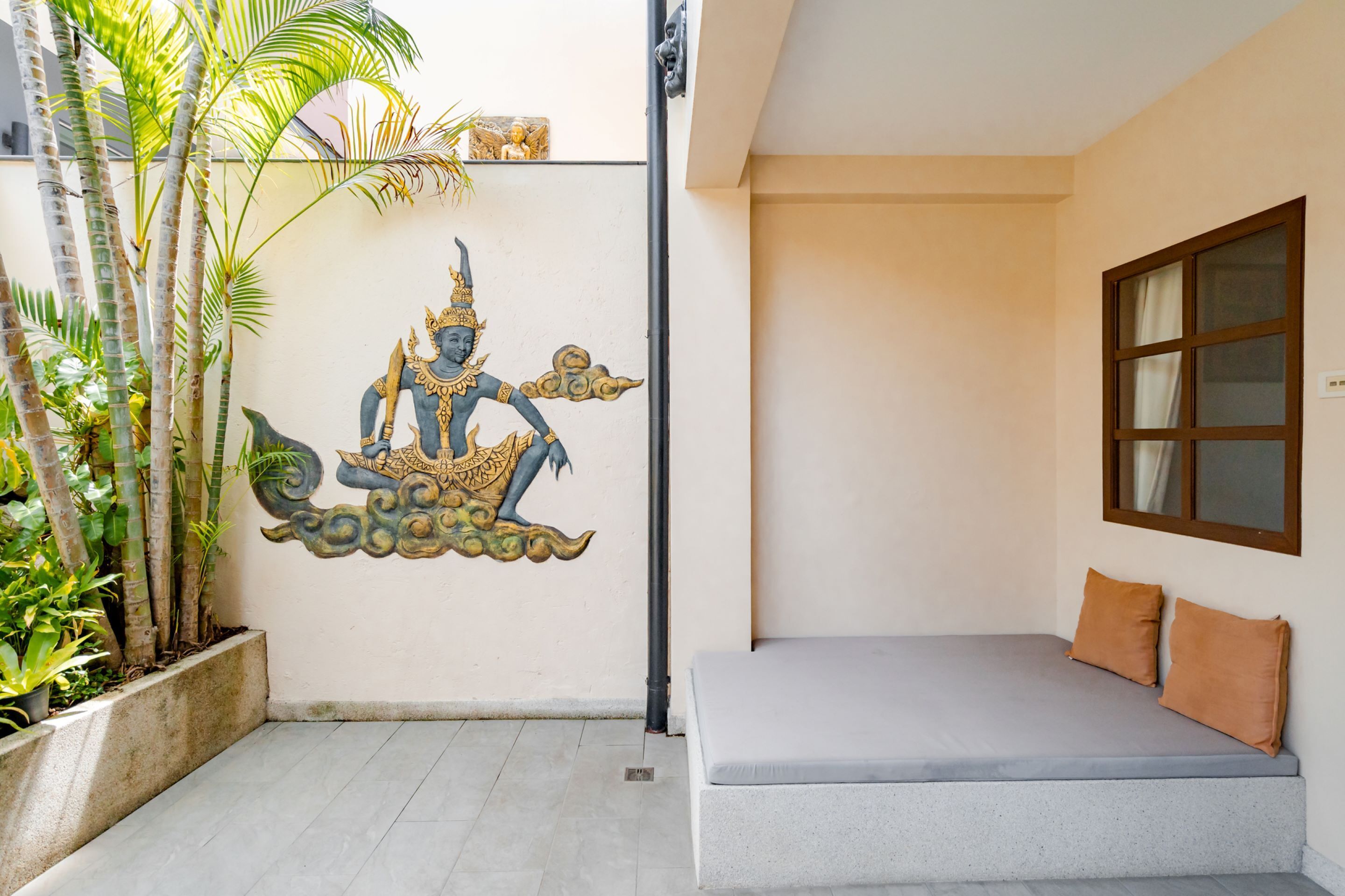 A room with a bed, a wall mural, and a window.