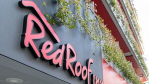 A building with a sign that reads "Red Roof Inn".