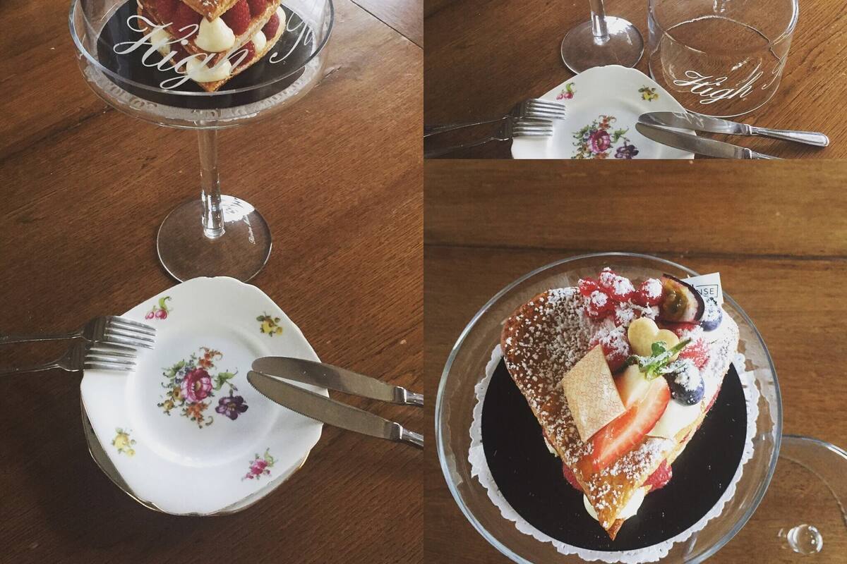 A dessert on a glass plate with a fork and knife beside it.