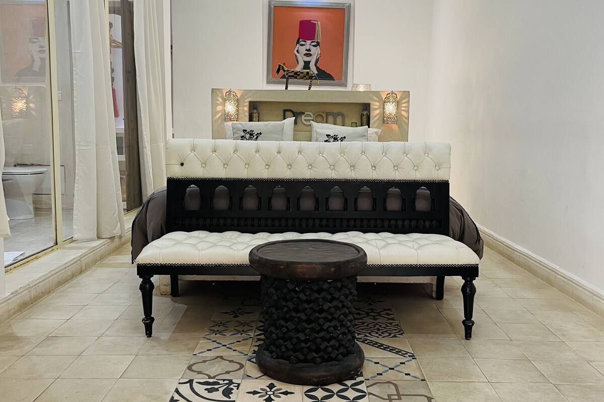 A modern living room with a sofa, a coffee table, and patterned tiles.