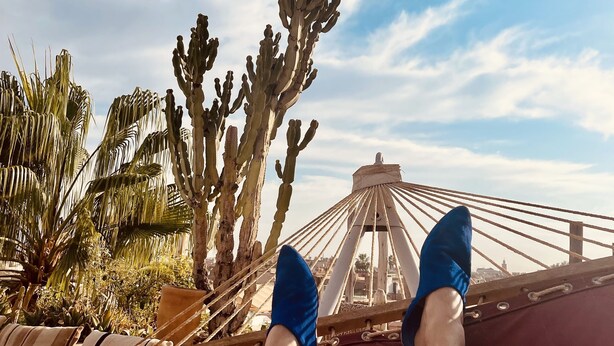 A hammock with a view of cacti and a bridge in the background. - Riad 144 (Marrakech)