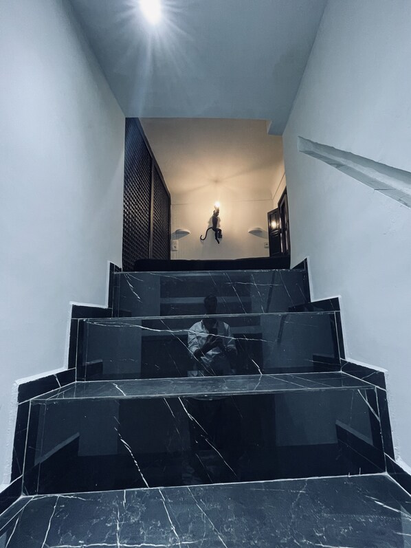 A staircase with black marble steps leading to a landing.