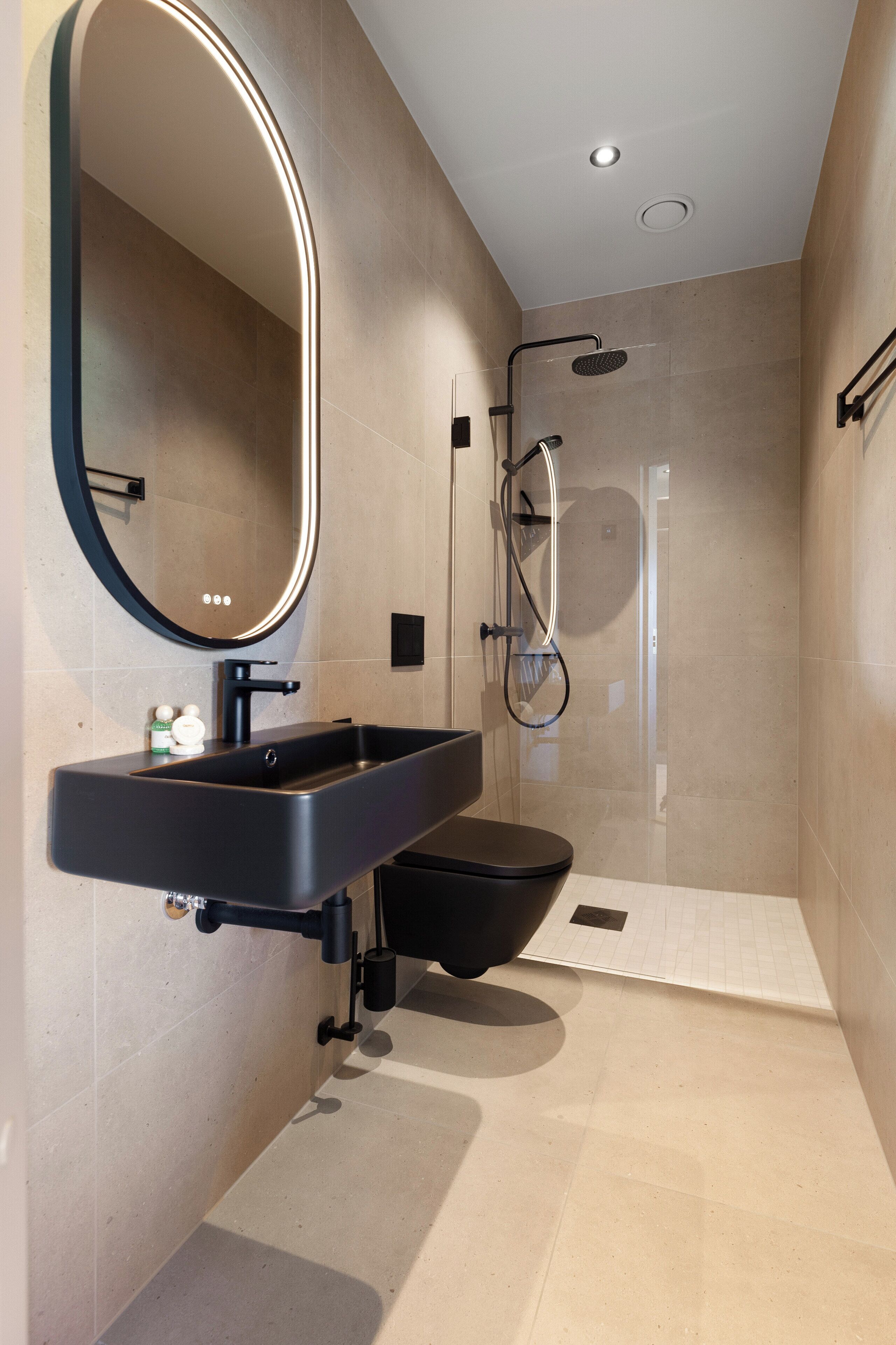 family room deluxe | bathroom | shower, rainfall showerhead, hair dryer, heated floors