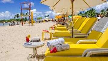 On the beach, sun loungers, beach umbrellas, beach towels
