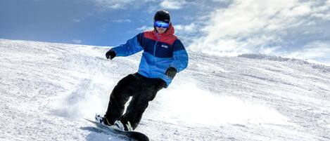 A person snowboarding on a snowy slope.