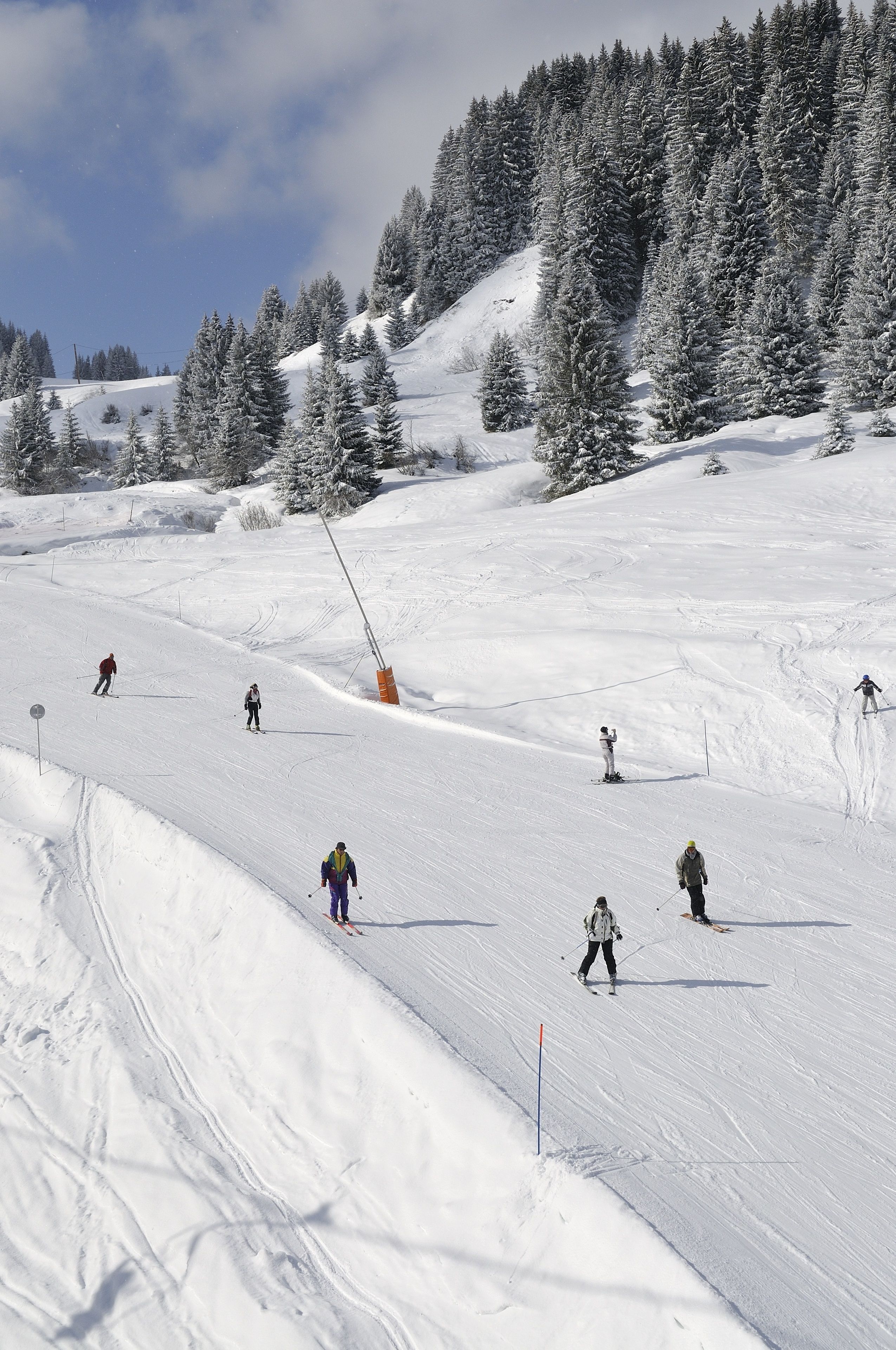 A ski slope with skiers descending.