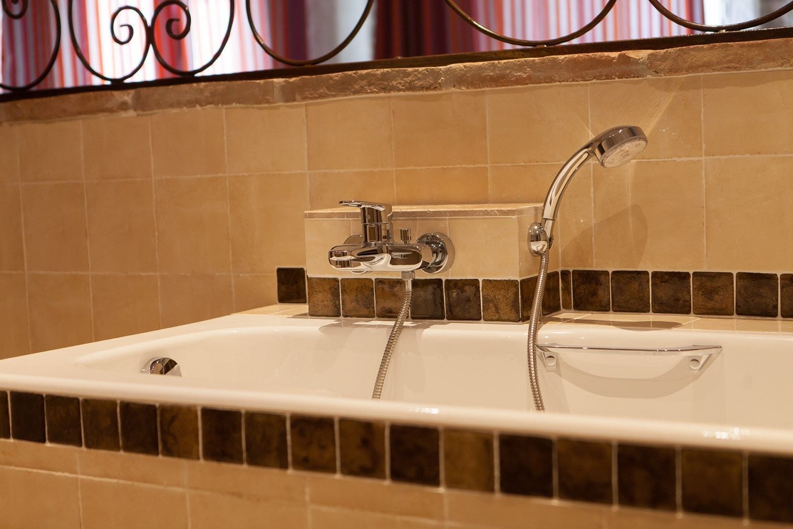 A bathroom with a bathtub, a shower, and a faucet.
