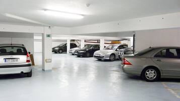 A multi-level parking garage with several cars parked.