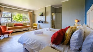 A hotel room with a large bed, a sofa, a chair, and a window with curtains. - Paternoster Hotel (Paternoster)