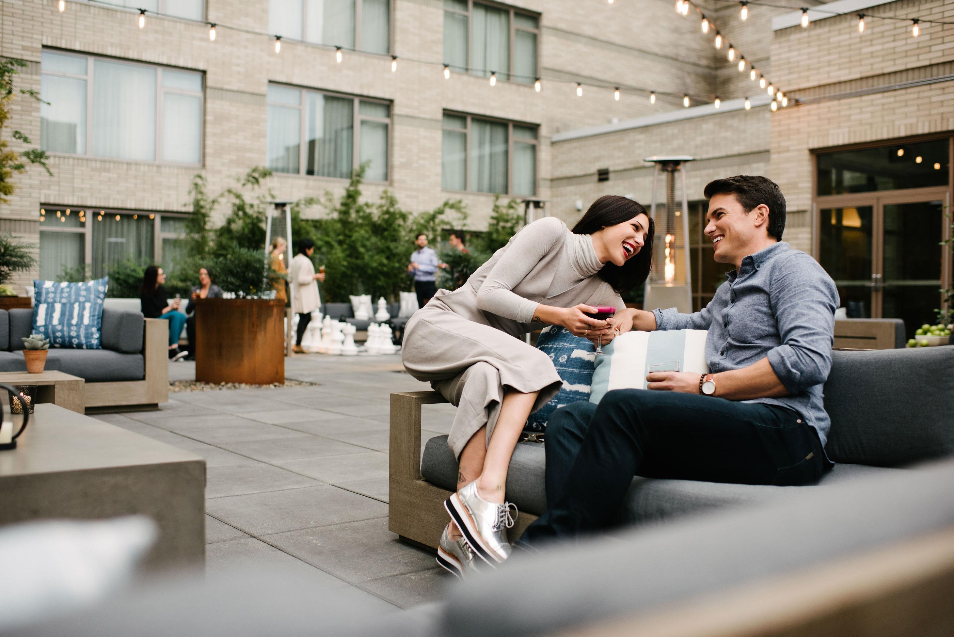 An outdoor seating area with a modern building in the background.