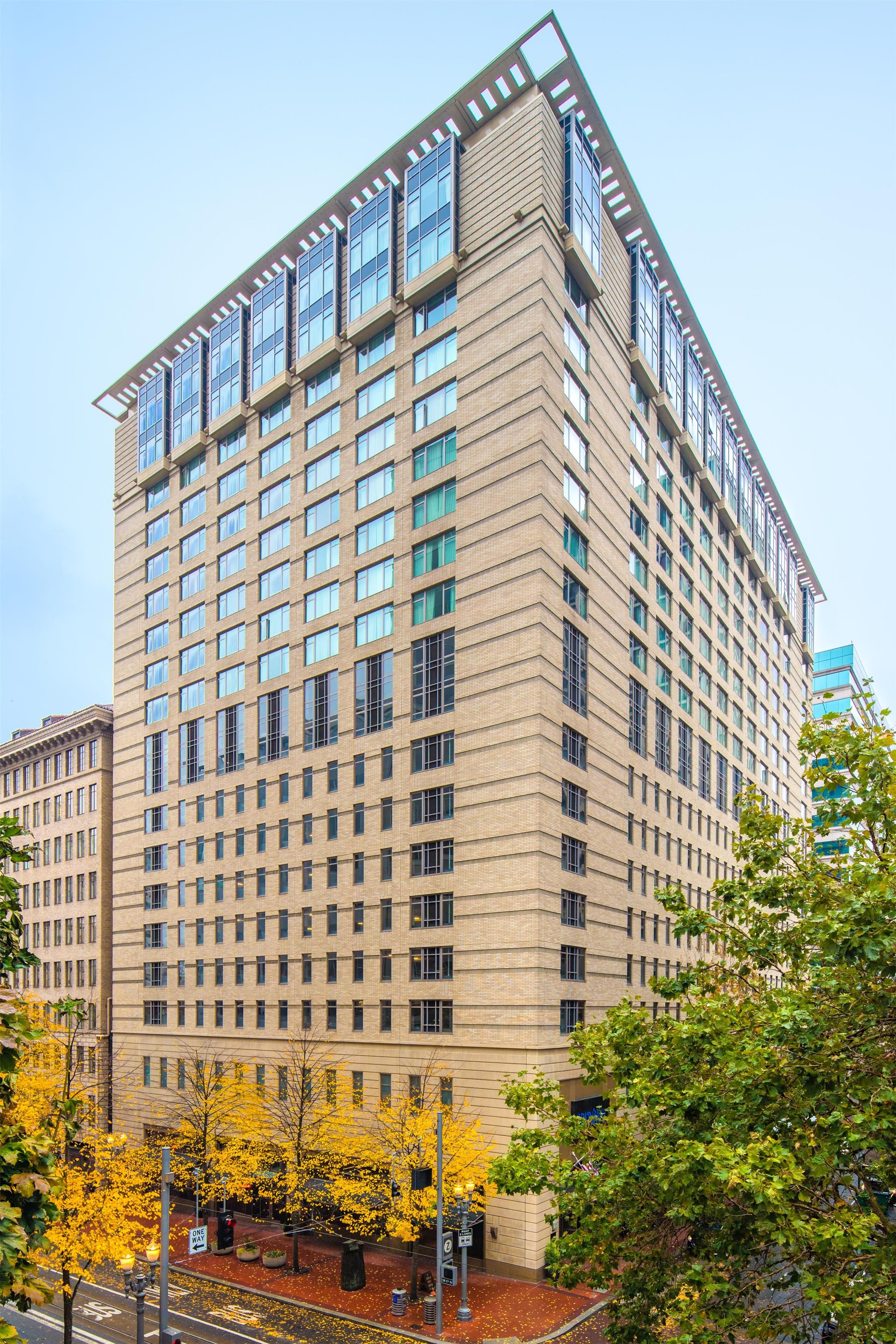 A multi-story building with a grid of windows and a flat roof.