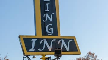 A tall sign with the words "STERLING INN" in white letters on a blue background.