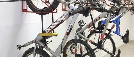 A bike rack with multiple bicycles.