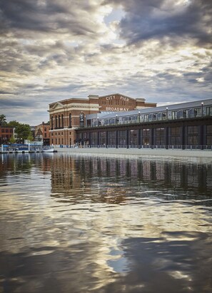 A waterfront view with a building labeled "City Pier Broadway." - Pendry Baltimore (Baltimore)