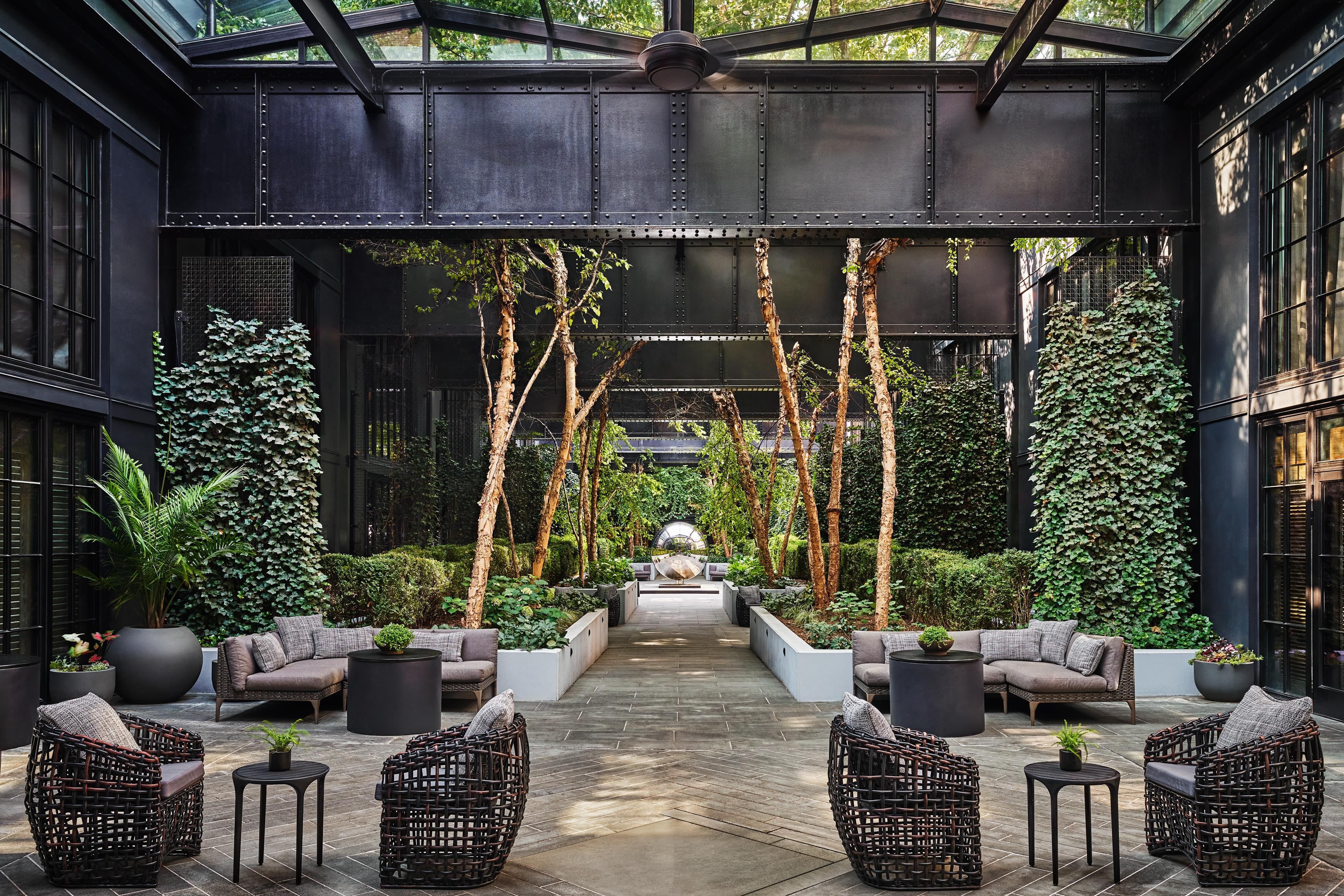 A covered outdoor area with seating and greenery.
