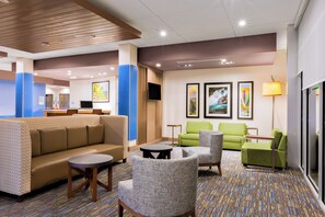 A hotel lobby with a seating area, a reception desk, and artwork on the walls. - Holiday Inn Express & Suites Prosser - Yakima Valley Wine by IHG (Prosser)