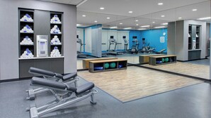 A modern gym with exercise equipment, mirrored walls, and a blue accent wall. - Fairfield Inn & Suites by Marriott Bakersfield North/Airport (Bakersfield)