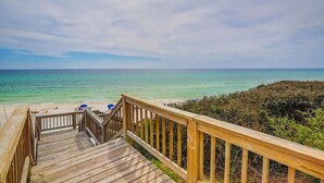 A wooden staircase leading to a beach with clear turquoise water and a view of the ocean. - 3 by the Sea 3 Bedroom Holiday Home by Five Star Properties (Panama City Beach)