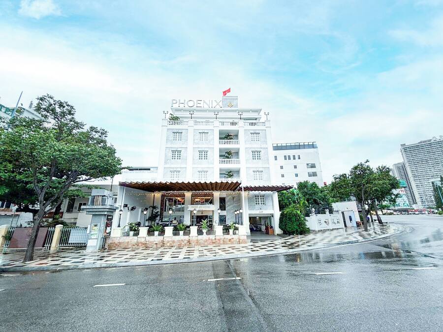 A hotel named 'PHOENIX' with a prominent sign, a covered entrance, and a number '249' on the facade.