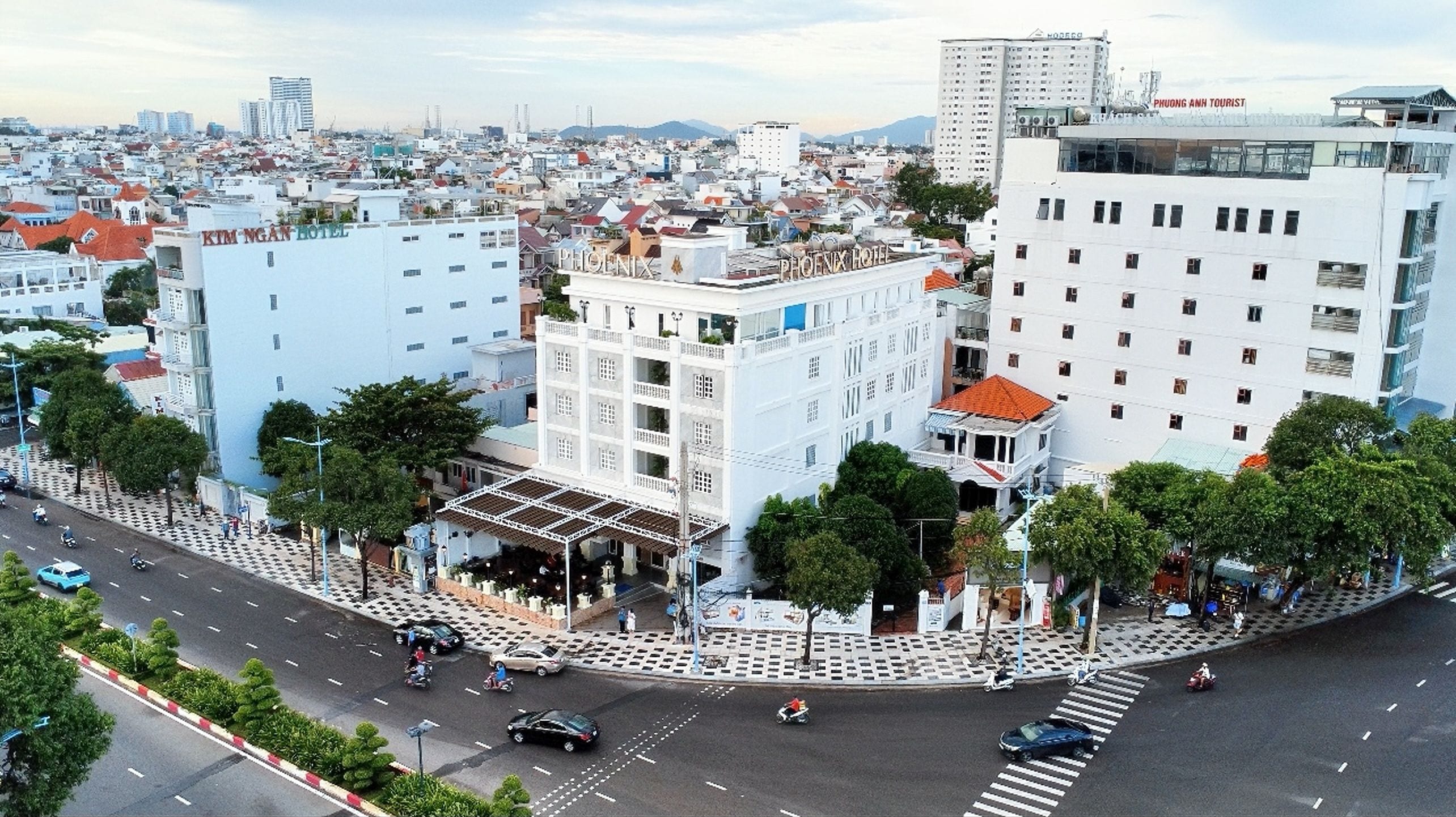A hotel with a central courtyard, multiple floors, and a prominent sign.