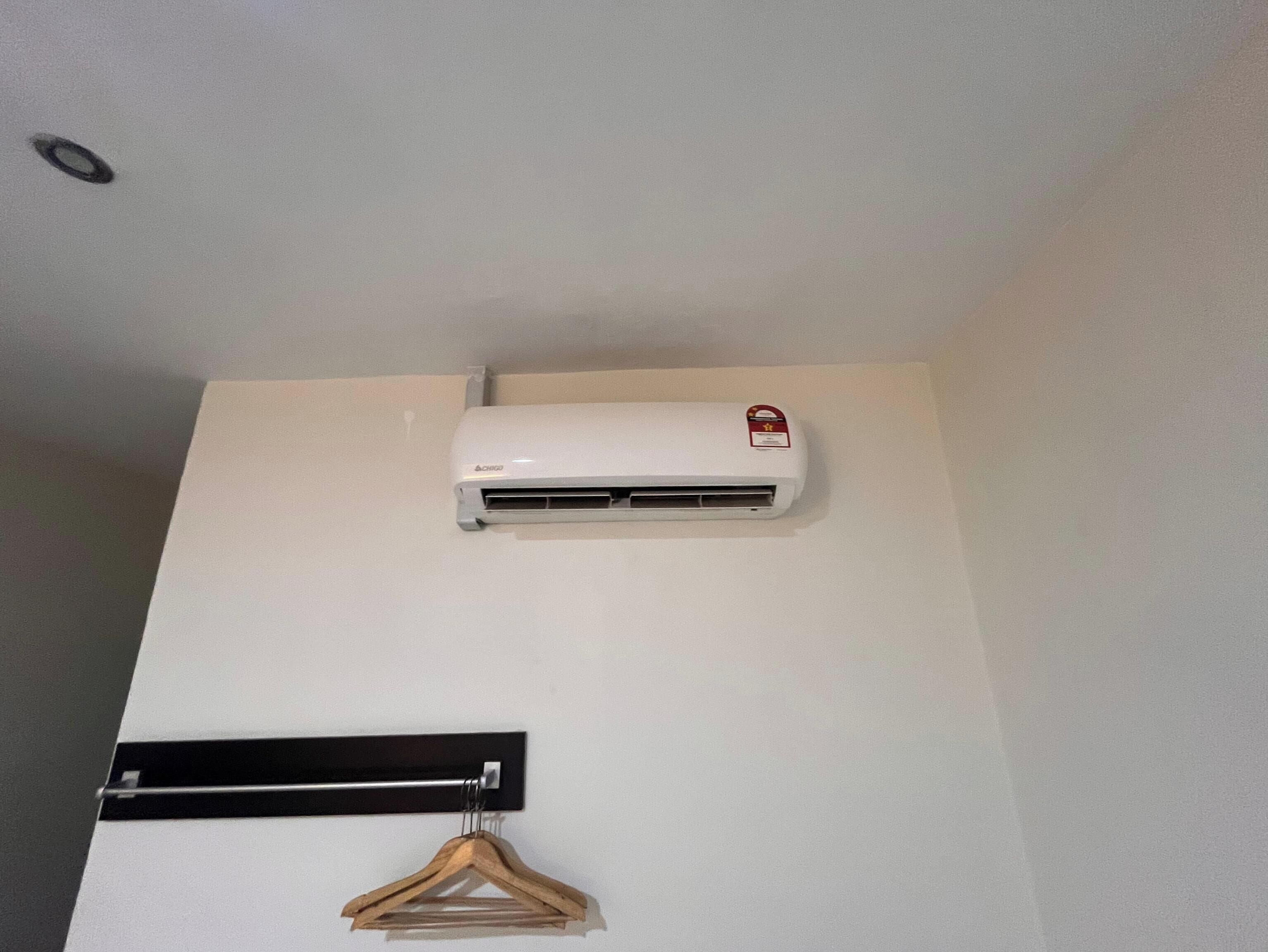 A white air conditioning unit mounted on a wall.