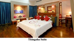A hotel room with a large bed, a sofa, a TV, and a desk with a lamp. - The Thingaha Nay Pyi Taw (Naypyidaw)