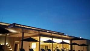 An outdoor seating area with umbrellas and chairs, likely part of a hotel or resort. - The Thingaha Nay Pyi Taw (Naypyidaw)