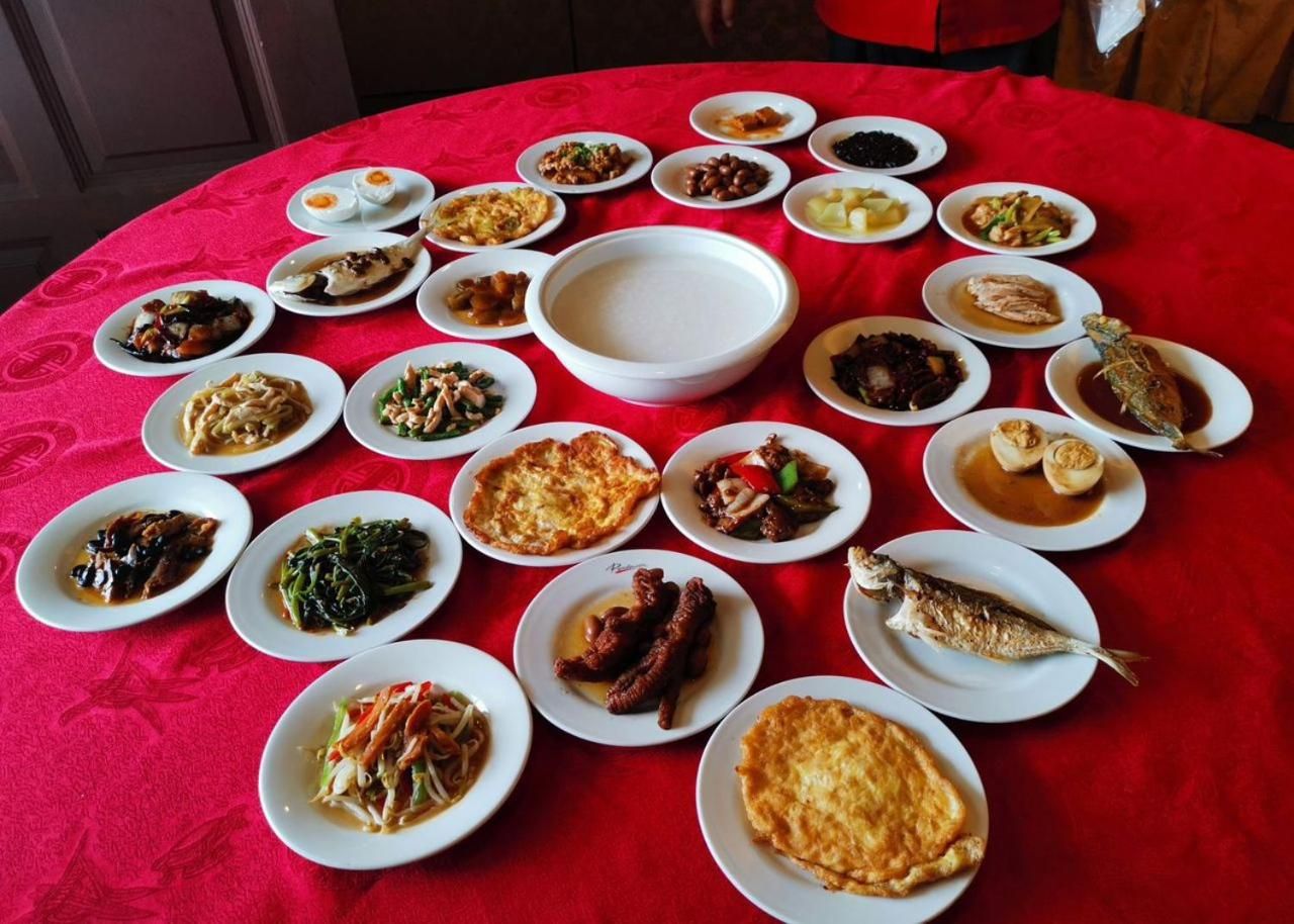 A table with various dishes arranged on a red tablecloth.