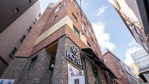 A hotel with a prominent 'A HOTEL' sign, a brick facade, and a clear sky in the background. - Itaewon A One Hotel (Seoul)