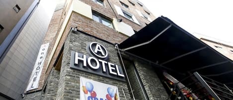 A hotel with a sign indicating a grand opening.
