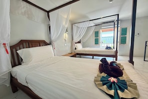 A hotel room with a large bed, a smaller bed, and a balcony with a view. - Sabaidee Chiangmai Hotel (Chiang Mai)