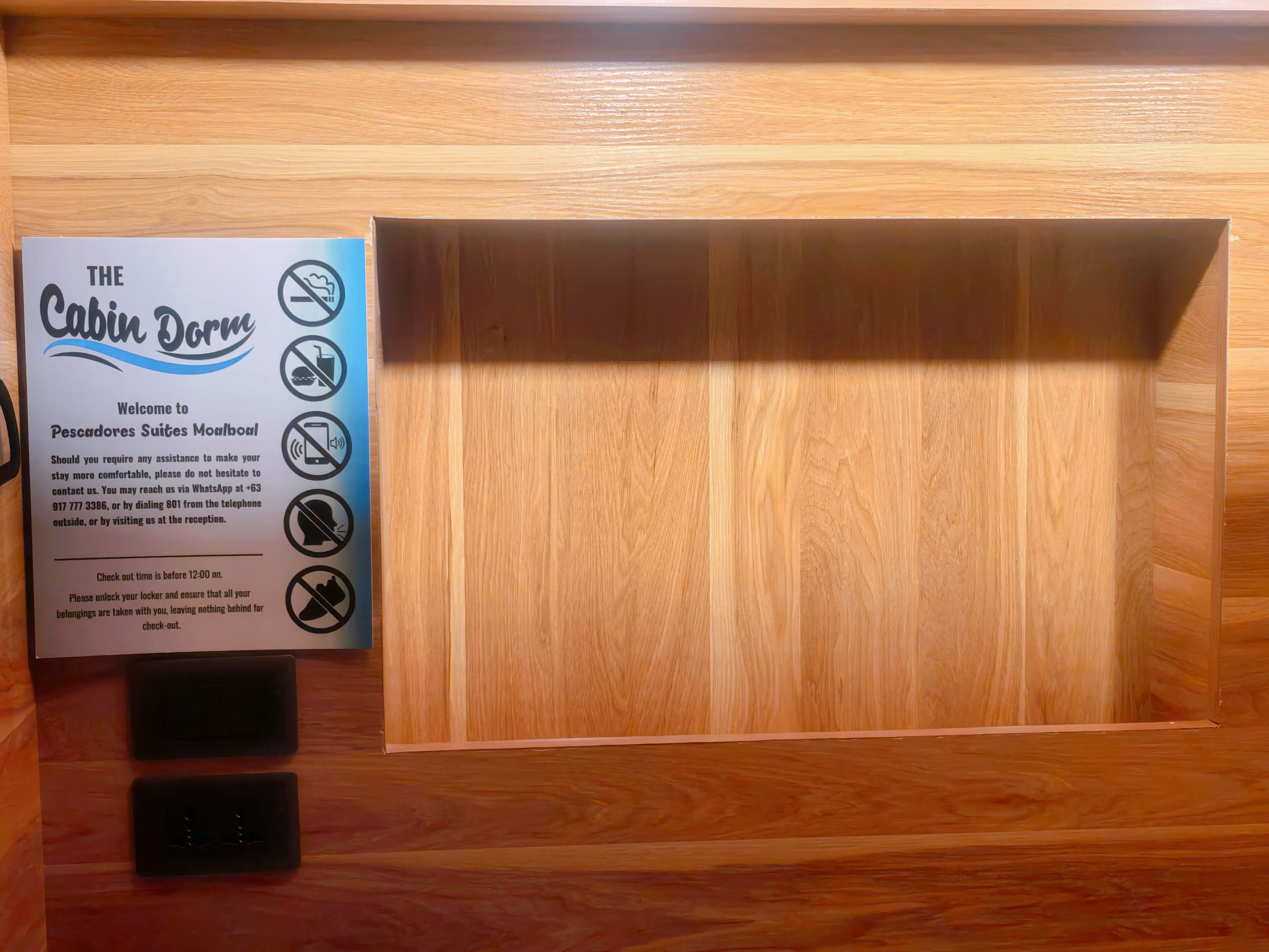 A wooden cabinet with a sign for 'The Cabin Door' and a lock mechanism.