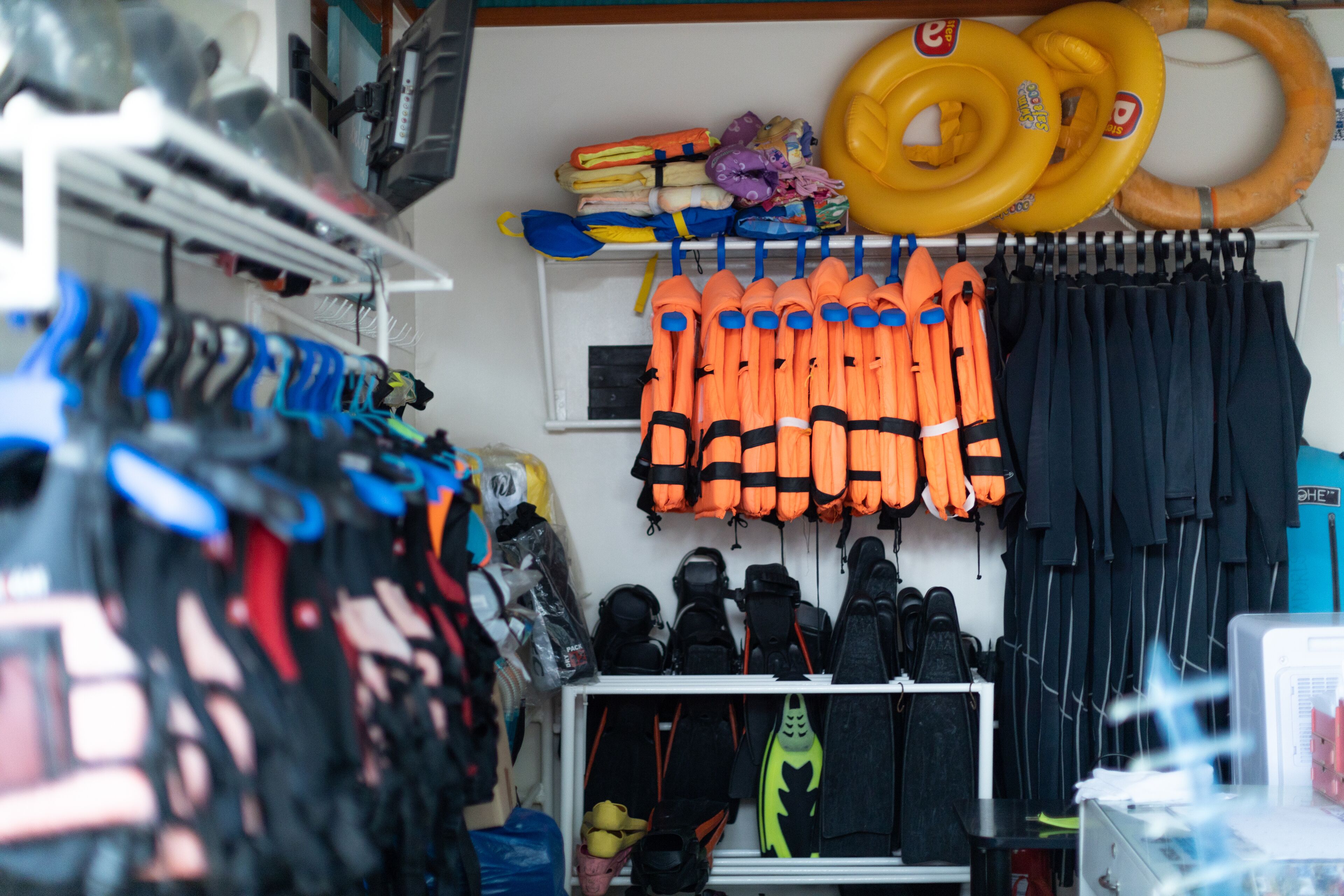 A storage area with life jackets, helmets, and other safety gear.