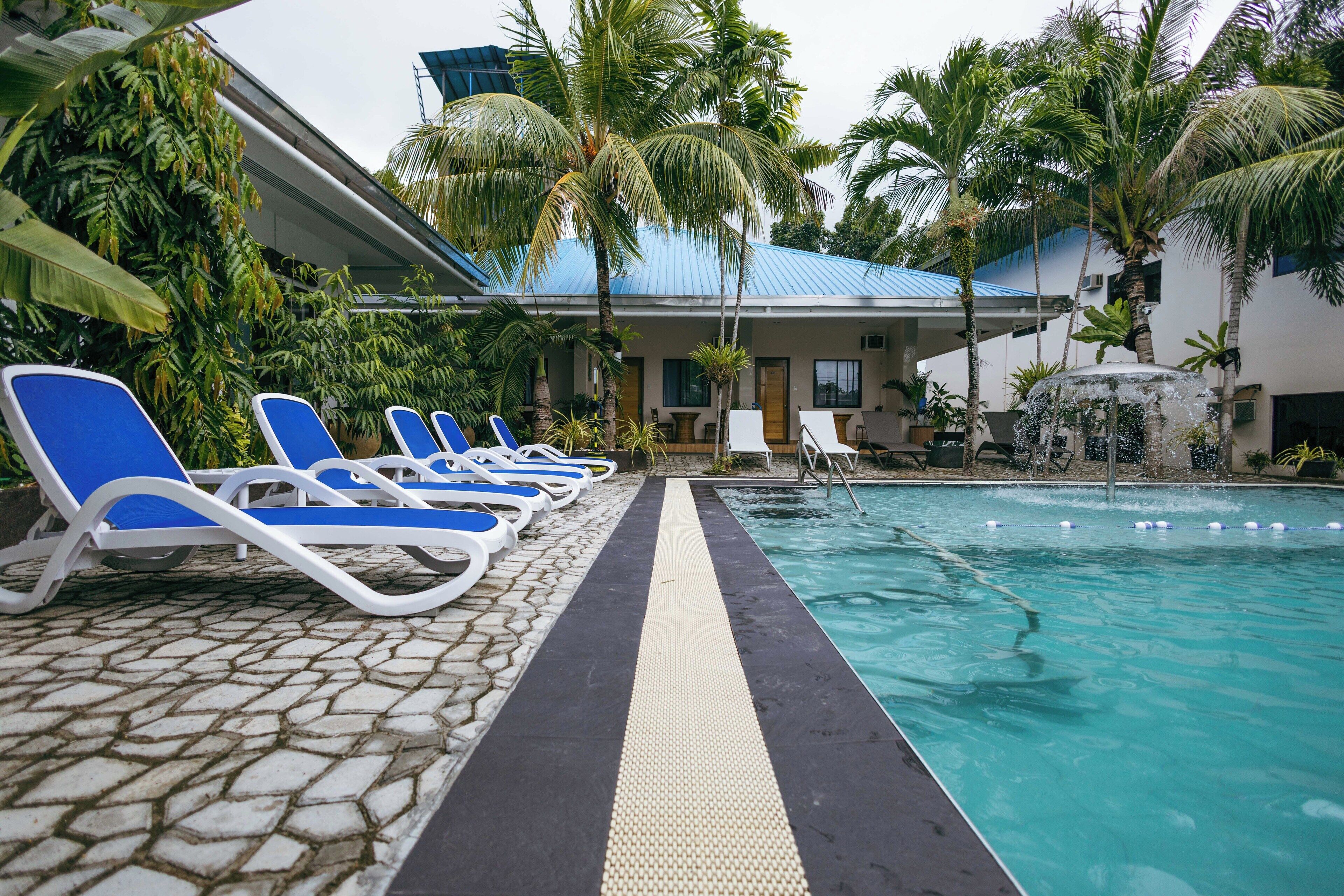 A pool area with lounge chairs and a clear water path.