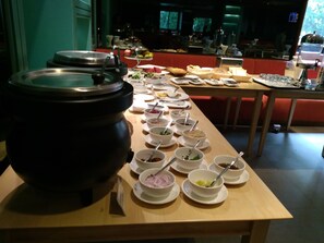 A buffet setup with various dishes and a large pot on a table. - The Link Yangon Boutique Hotel (Yangon)
