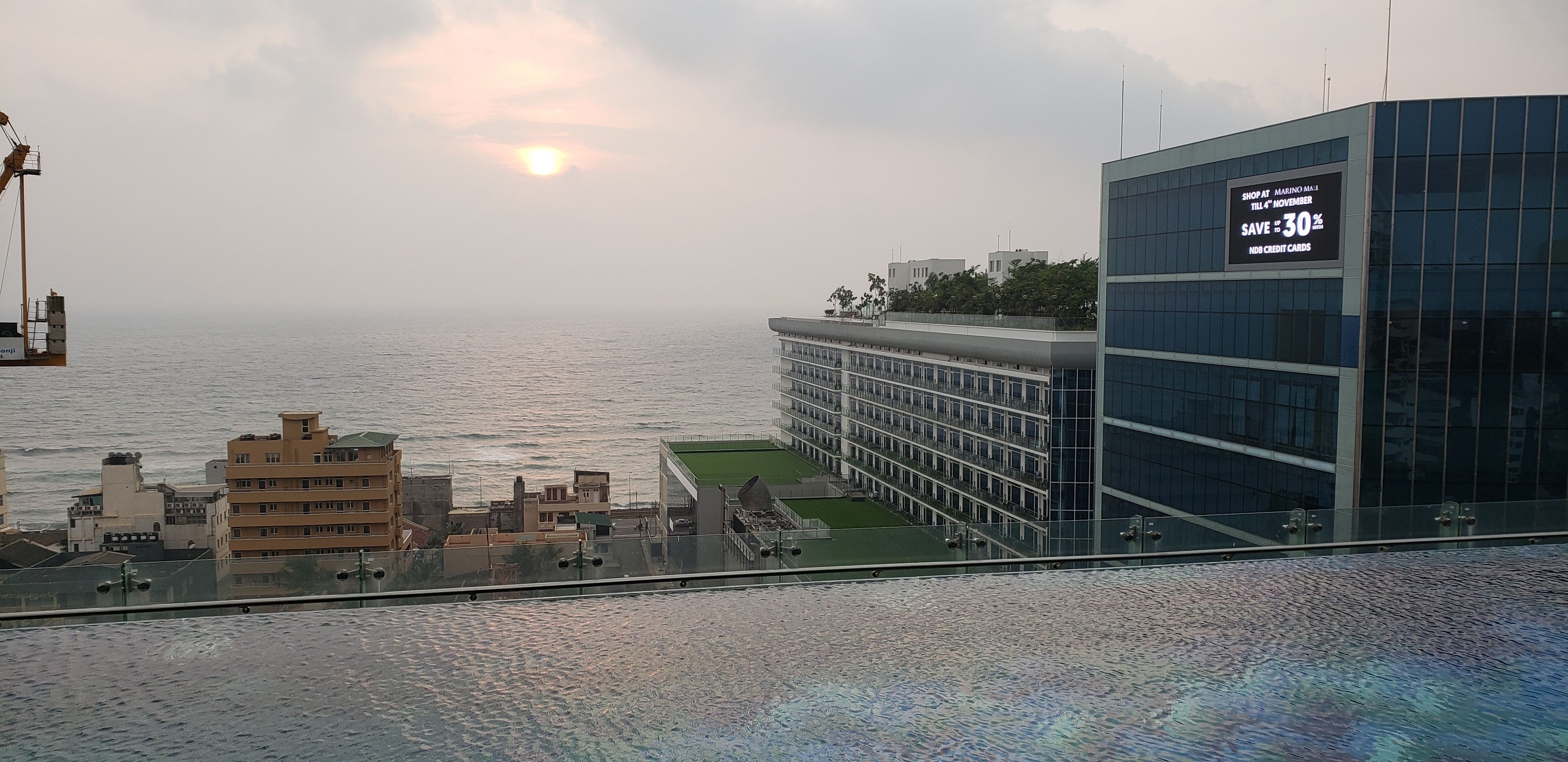 Un edificio moderno con fachada de vidrio y vista al mar.