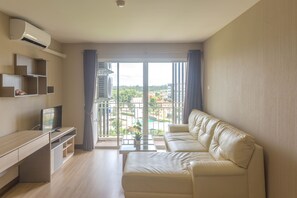 Deluxe Family Room | Living room | Flat-screen TV - Life Grand Hotel (Chiang Mai)