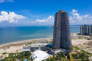 A high-rise hotel with a curved design, beachfront location, and a large central courtyard. - Forest City Marina Hotel (Gelang Patah)
