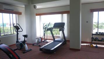 A gym with treadmills, an elliptical, and a stationary bike.