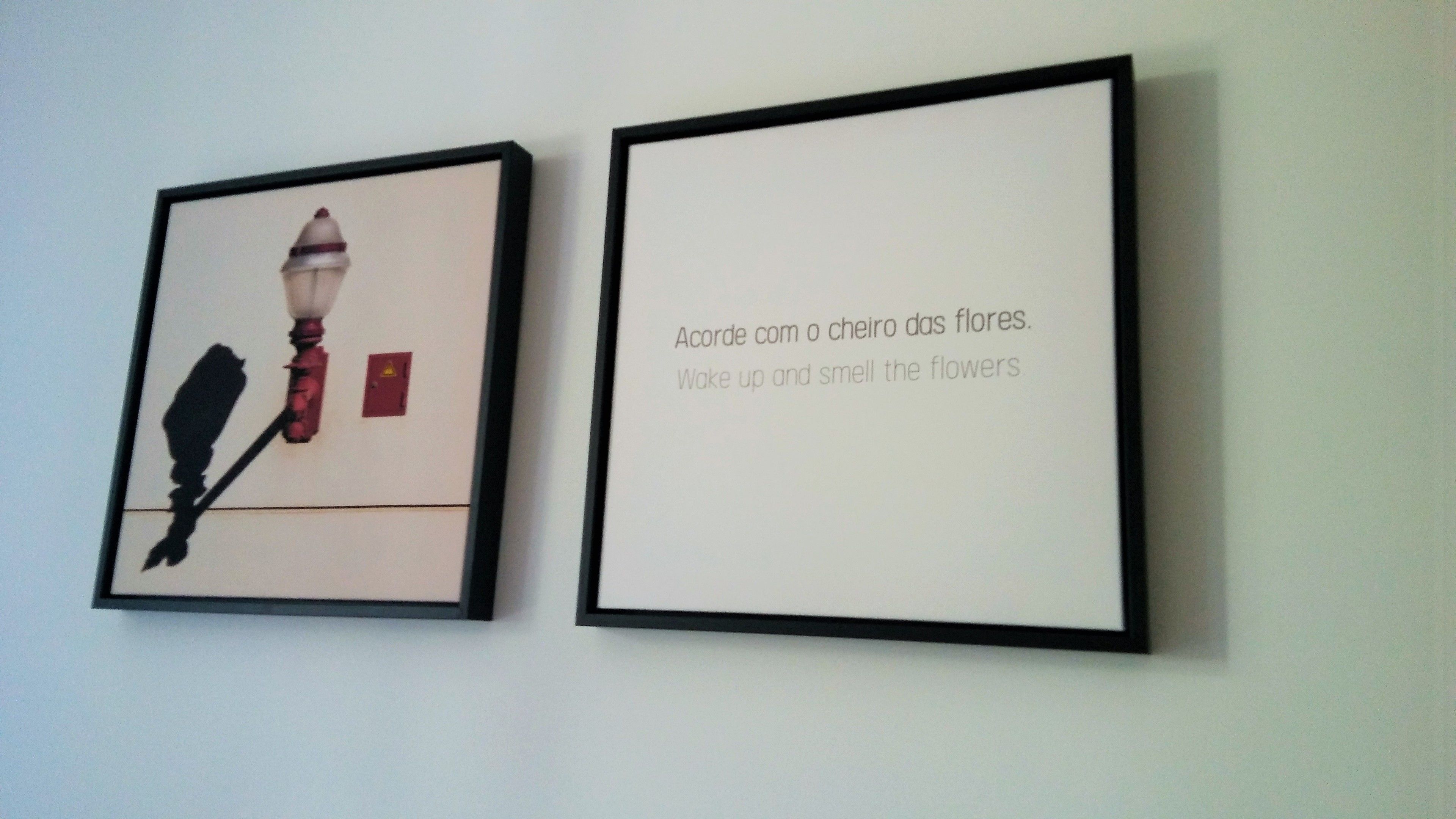 Two framed artworks on a wall.