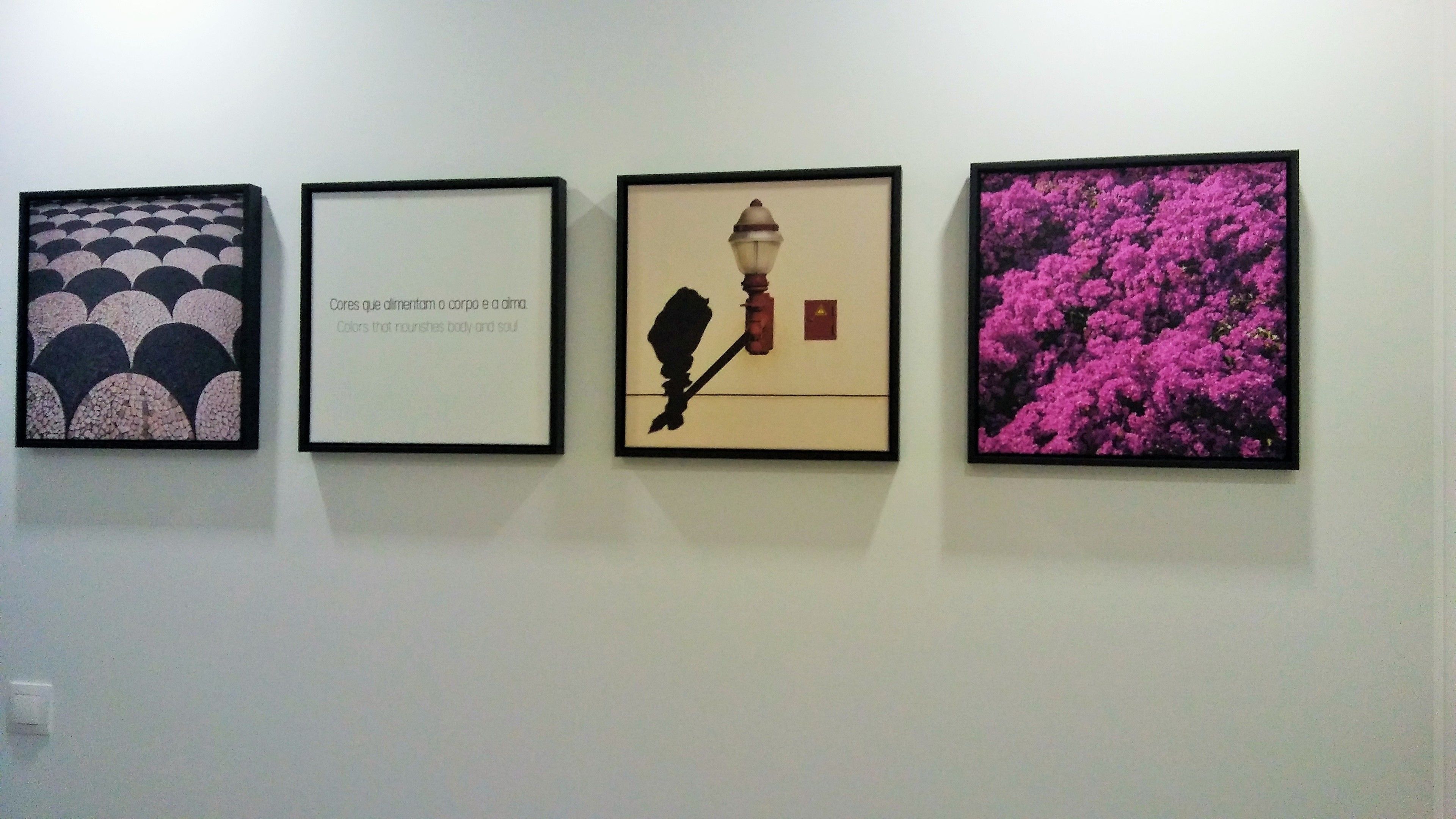 Four framed artworks on a wall.