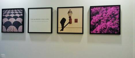 Four framed artworks on a wall.