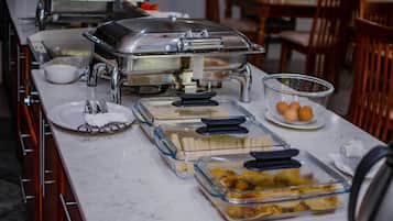 A buffet setup with various food items and serving dishes.