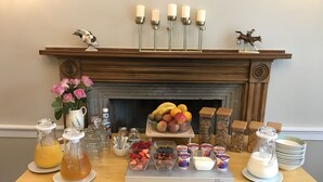 A breakfast table with fruits, beverages, and condiments. - West Plean House (Stirling)