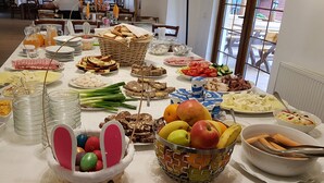 Une table de buffet garnie de divers plats et agrémentée d’un décor central représentant un lapin de Pâques.
