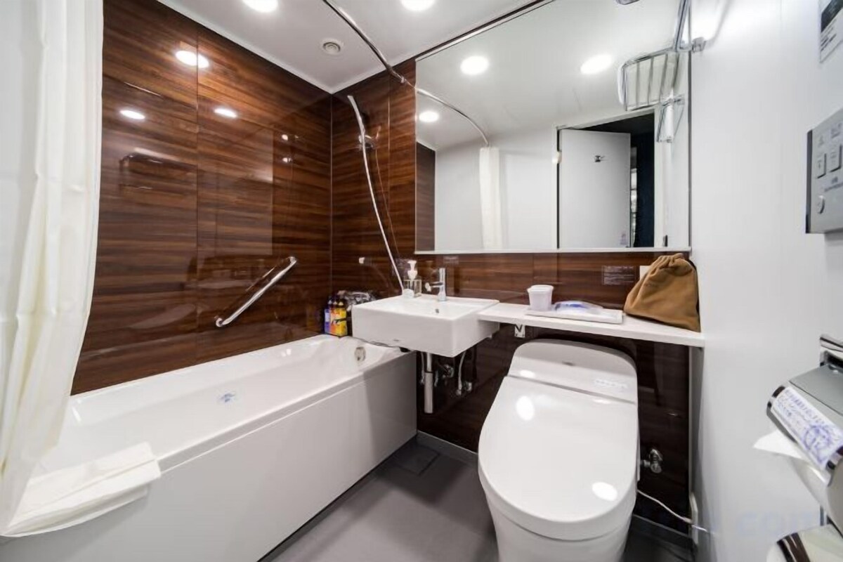 Un baño moderno con bañera, inodoro y tocador.