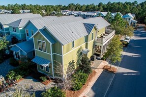 A residential area with multiple two-story houses featuring gabled roofs and front porches.