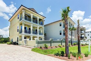 A multi-story residential building with balconies, a paved driveway, and landscaped gardens. - DaShells30A 6 Bedroom Holiday Home by Five Star Properties (Santa Rosa Beach)