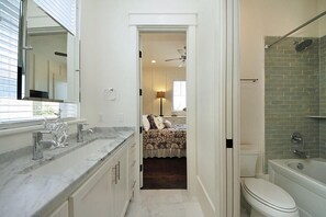 A bathroom with a bathtub, toilet, and a shower area. - DRIFTWOOD 5 Bedroom Holiday Home by Five Star Properties (Santa Rosa Beach)