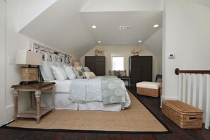 A bedroom with a large bed, bedside tables, a dresser, and a window. - DRIFTWOOD 5 Bedroom Holiday Home by Five Star Properties (Santa Rosa Beach)